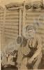 Soldier with goggles, sitting in trench with small