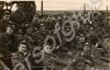 Group of soldiers sitting on a bank in front of a