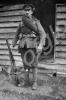 Soldier standing outside hut. 12th Battalion, The