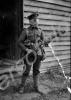 Soldier wearing early gas mask, standing outside h