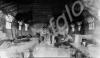 Group of soldiers sitting inside hut. 12th Battali